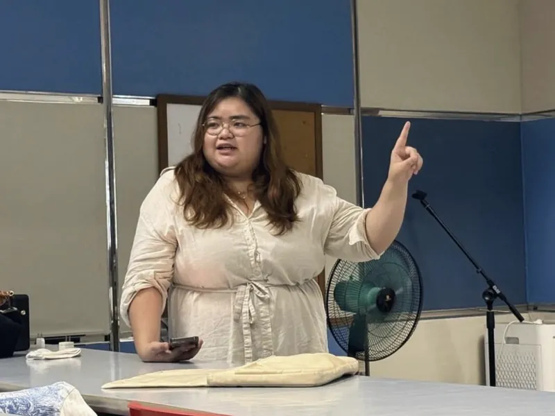 A speaker pointing to the room during a Startup Spark session