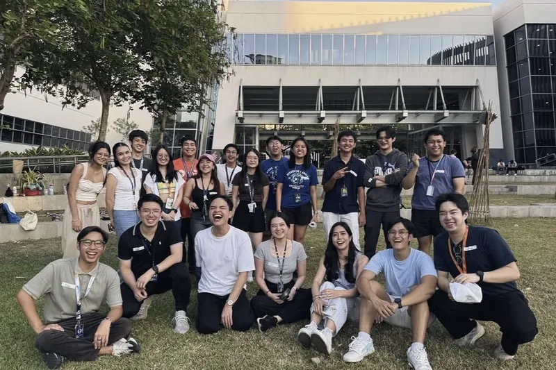 Members sitting together on the grass