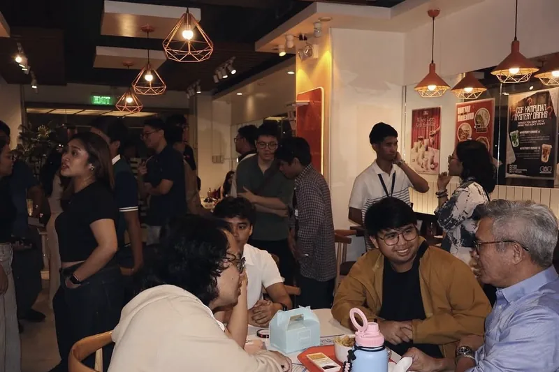 Members talking with a mentor over coffee