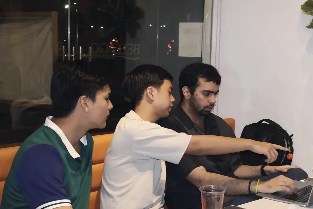 Three members working on a laptop together